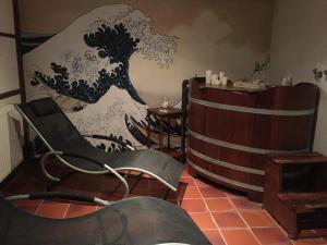 a living room with a wave mural on the wall at Ferienwohnung Spatzennest in Prerow