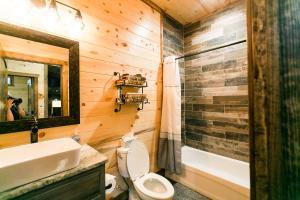 une salle de bain avec toilettes, lavabo et miroir dans l'établissement Fireside Creek Luxury Cabin, à Stephens Gap 57 autres photos