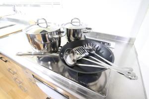 a frying pan and utensils on a stove at Fukuoka - Apartment / Vacation STAY 49381 in Fukuoka