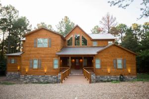 a large wooden house with a front porch at The Party of Five Lodge in Stephens Gap