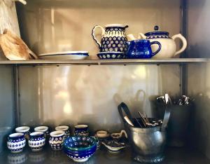 a shelf with blue and white ceramics on it at Hof van Eersel in Eersel