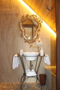 a bathroom with a sink and a mirror on a wall at Steirisch Ursprung in Gleisdorf