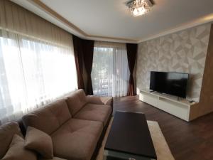 TV a/nebo společenská místnost v ubytování City Center Lux Apartment