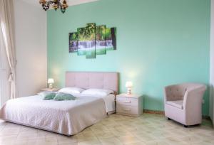 a bedroom with a white bed and a chair at Sorrento Hills in Sorrento