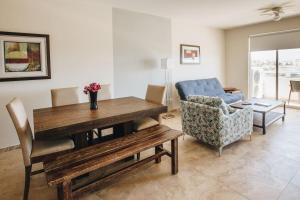 uma sala de estar com uma mesa de madeira e um sofá em Cabo Cottage Bahia del Tezal em Cabo San Lucas