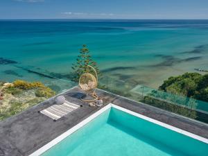 a swimming pool with a view of the ocean at Sueño LUXURY VILLA, in Argasi 180 Iconic Sea View in Argasi