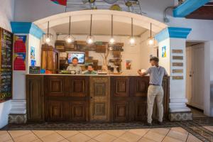 a man standing in front of a counter in a kitchen at Selina Granada in Granada