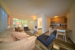 a living room with a couch and a table at Club Lux Resort By The Beach in Deerfield Beach