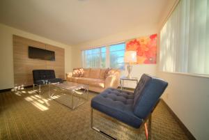 a living room with a couch and a chair at Club Lux Resort By The Beach in Deerfield Beach