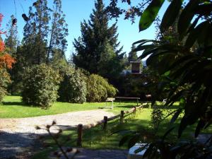 a park with a wooden fence and a goal at Cabañas Auquin Lemu in Lago Puelo +12 photos