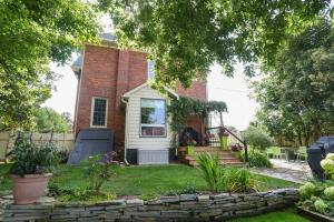 a home with a brick house with a yard at Danby House in Markdale