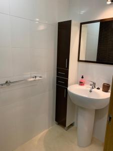 a bathroom with a sink and a mirror at Oktheway Novo Freiré in Lugo