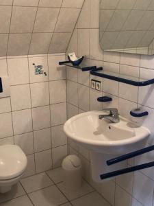 a bathroom with a sink and a toilet at Gasthof zum Hirsch in Sachsenheim