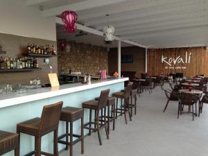 a restaurant with a bar with chairs and tables at Lagomandra Hotel and Spa in Lagomandra