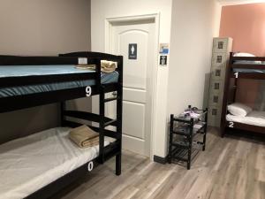 a room with three bunk beds and a hallway at 8th and Ardmore in Los Angeles