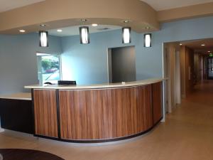 a lobby with a reception desk in a building at Studio 6 Suites Hinesville, GA in Hinesville