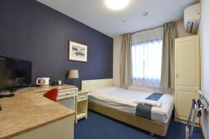 a hotel room with a bed and a desk at New Osaka Hotel Shinsaibashi in Osaka +97 photos