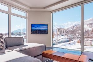 a living room with a couch and a table at Bluebird Apartments by The Hakuba Collection in Hakuba