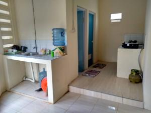 a kitchen with a sink and a counter top at West Surabaya Homey in Surabaya +19 photos