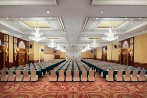 a large room filled with chairs and tables at The Emerald Hotel - SHA Extra Plus in Bangkok