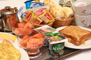 a tray of food with sandwiches and other snacks at Vitara Motel (Adult Only) in Taboão da Serra