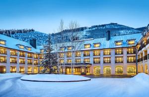 a large building with snow on the ground at Grand Hyatt Vail in Vail