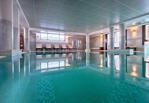 a large swimming pool in a hotel room at Hyatt Regency Nice Palais de la Méditerranée in Nice