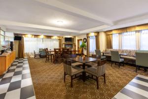 a living room with a table and chairs at Days Inn by Wyndham Petoskey in Petoskey