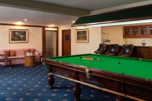a large room with a pool table and chairs at The Emerald Hotel - SHA Extra Plus in Bangkok