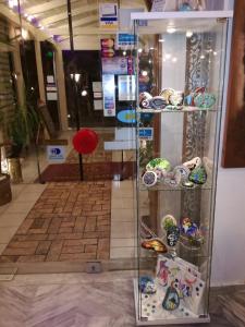 a glass display case filled with lots of different items at Krikonis Hotel in Ioannina