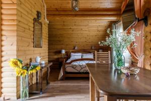 a room with a bedroom with a table and a bed at Tourist Complex belaya Reka Dakhovskaya in Dakhovskaya