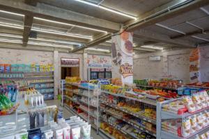 a grocery store aisle with a lot of food at RedDoorz Syariah near Universitas Negeri Gorontalo 2 in Gorontalo +18 photos