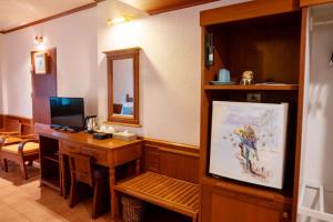A television and/or entertainment center at Coral Cliff Beach Resort Samui - SHA Plus