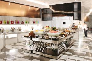 eine Küche mit einem Buffet mit Speisen auf der Theke in der Unterkunft Holiday Villa Hotel & Residence City Centre Doha in Doha