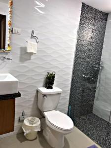 a bathroom with a toilet and a shower at Fully Equipped New 1br Apt–dt–2mins To Beach in Sosúa