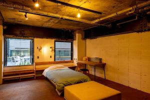 a room with a bed and a desk in it at Guest House M104 Kagoshima in Kagoshima