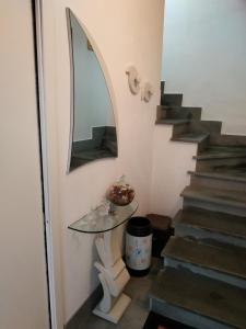a stairway with a glass table and a mirror at CARRELA 'E BRETA in Thiesi