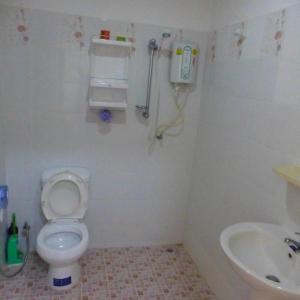 a bathroom with a toilet and a sink at 1 Double bedroom apartment with Pool and extensive Kitchen diningroom in Ban Sang Luang