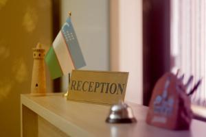 a sign that says depreciation sitting on top of a table at Ismail in Bukhara
