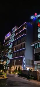 a large building with a sign on it at night at Hotel Broadway Yangon in Yangon