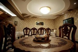 a dining room table with chairs and a bowl on it at Ismail in Bukhara
