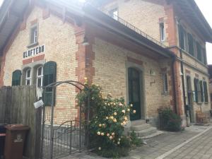 a brick building with a gate in front of it at Historischer Bahnhof in Friedrichshafen