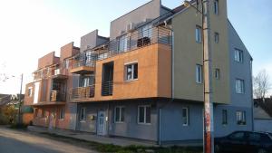 a building with balconies on the side of a street at Apartman Tatjana in Novi Sad