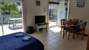 a bedroom with a bed and a table and a television at Le Moulin à Rêves in Talmont