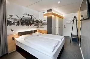 a bedroom with a bed with a picture of a helicopter at Airport Hotel, Billund in Billund