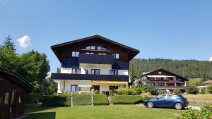 a house with a car parked in front of it at Appartment Haus Birgit in Seefeld in Tirol