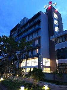 a large building with a sign on top of it at Hotel Broadway Yangon in Yangon