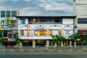 a building with a pharmacy on the side of a street at Kandy City Hotel by Earl's in Kandy