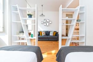 a bedroom with white shelving and a blue couch at Modern Apartment in the Historical Center in Lisbon