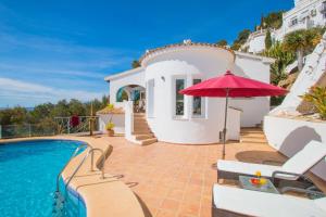 a villa with a swimming pool and a house at Casa Infinidad in Moraira